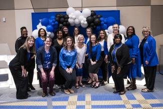 Sarah Bennett Holmes Award Event, UKWF board members standing by balloon background